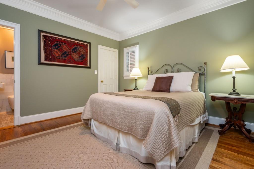 676 Clifton Road Northeast Atlanta, GA 30307 - Photo 22 of 45 a bedroom with a bed and a lamp