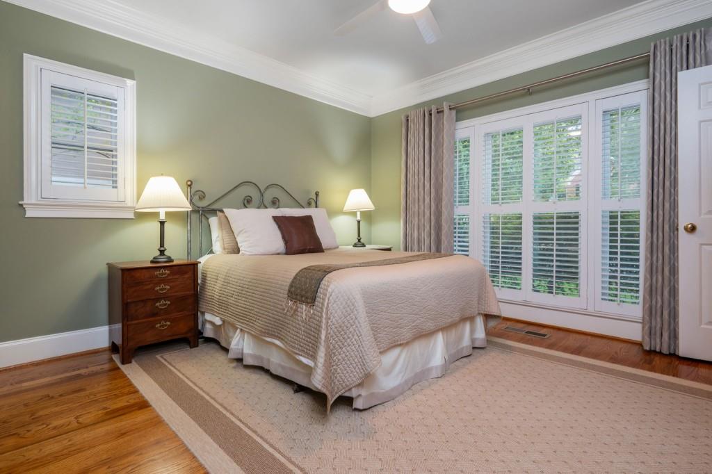 676 Clifton Road Northeast Atlanta, GA 30307 - Photo 23 of 45 a bed sitting in a bedroom next to a window