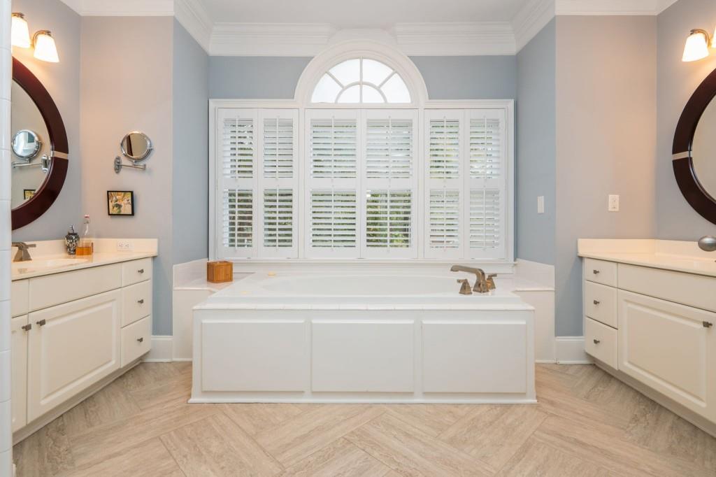 676 Clifton Road Northeast Atlanta, GA 30307 - Photo 30 of 45 a bathroom with a bathtub a sink and a large mirror