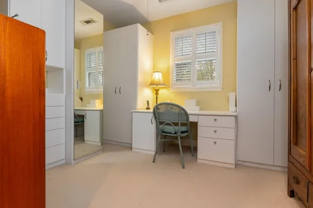 a livingroom with workspace and a window