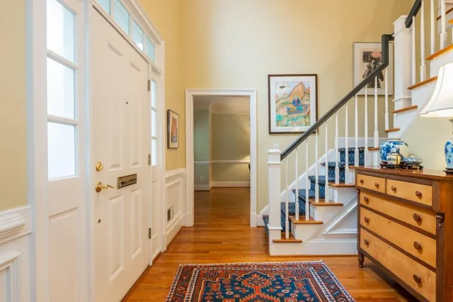 a view of entryway with wooden floor and stairs