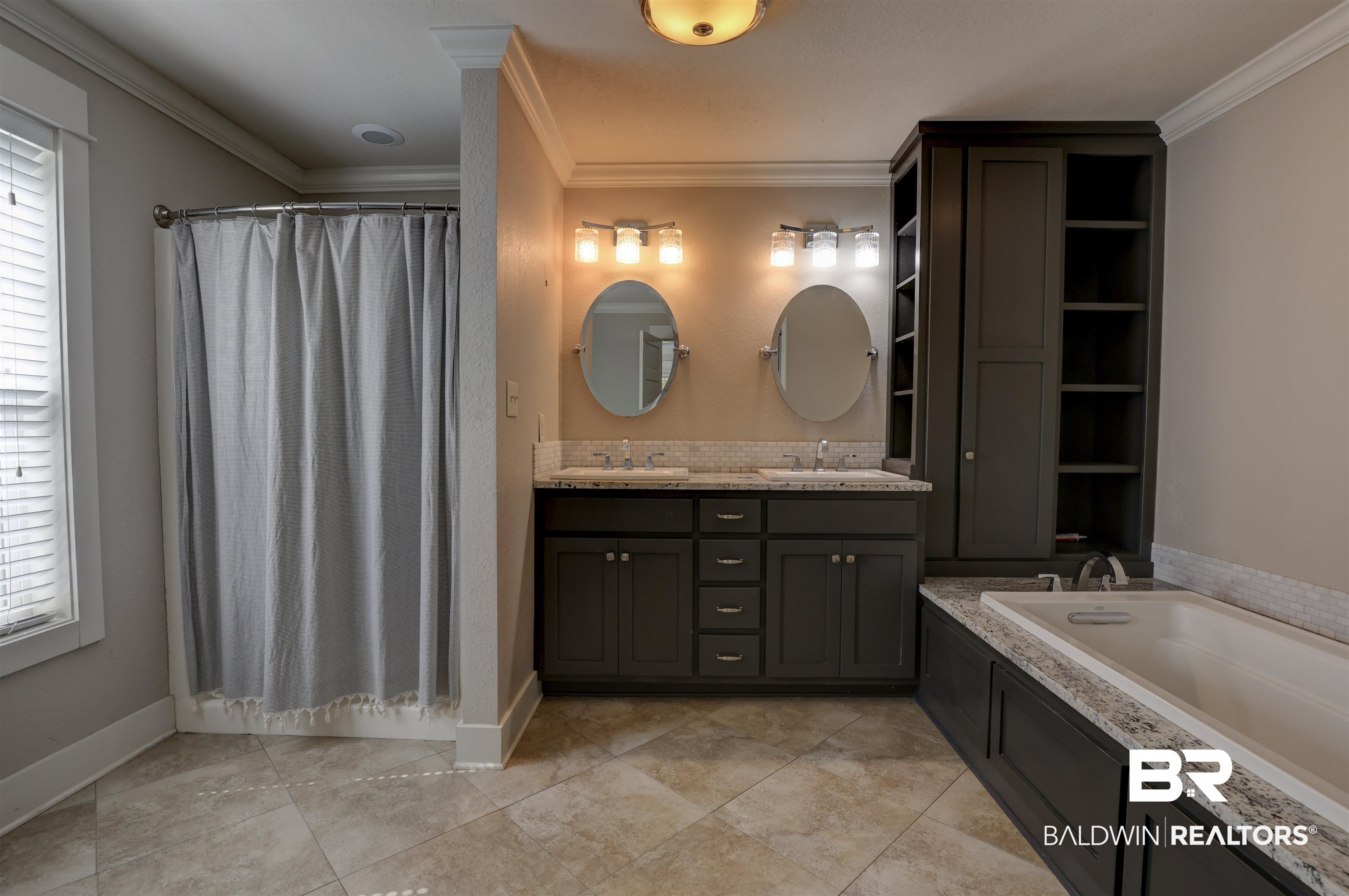 2079 Alabama Street Loxley, AL 36551 - Photo 18 of 42 Bathroom with tile patterned flooring, double vanity, a bath, and ornamental molding