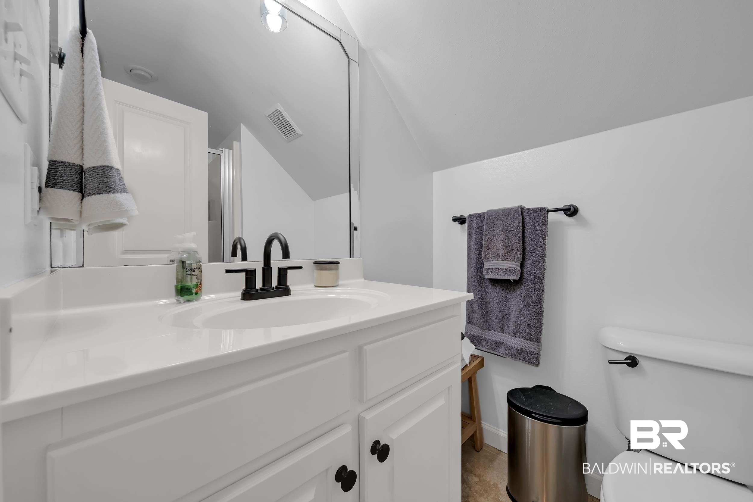 8137 Pine Run Daphne, AL 36527 - Photo 39 of 67 Vanity with integrated sink, matte black faucet, and white cabinetry featuring black hardware