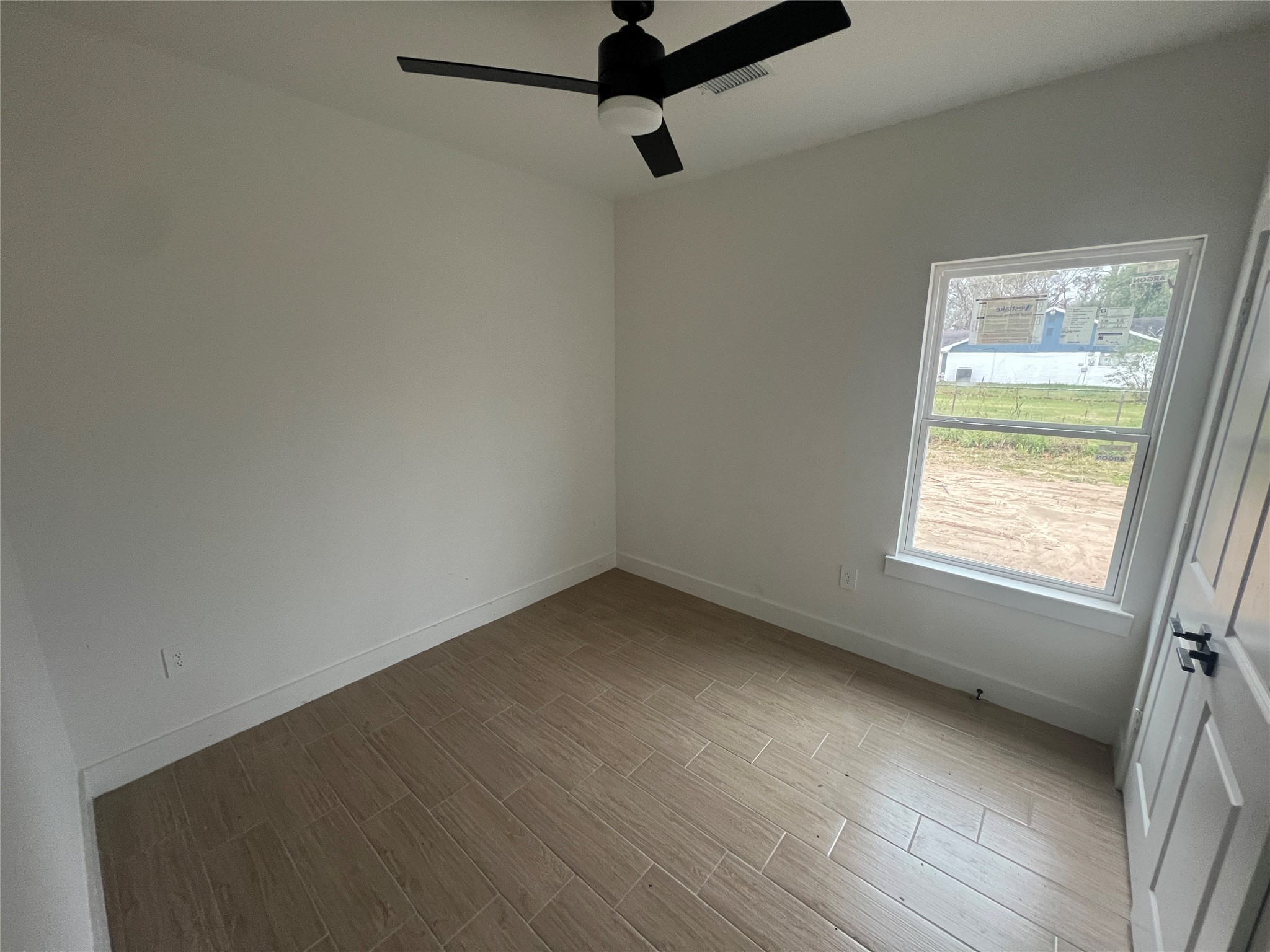 5710 Delmack Street, Unit A Houston, TX 77032 - Photo 4 of 10 an empty room with a window