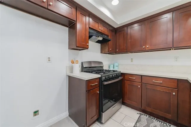 a kitchen with stainless steel appliances granite countertop a stove and a sink
