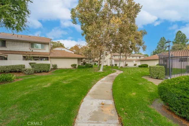 a view of a house with a yard and sitting area