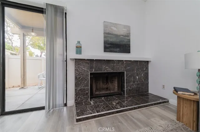a living room with a fireplace and a glass door