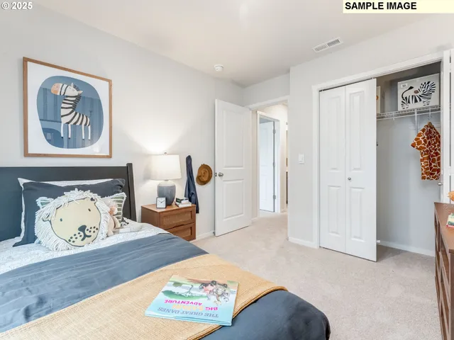 a bedroom with a bed and painting on the wall