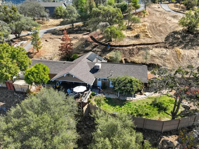 an aerial view of a house with a yard basket ball court and outdoor seating