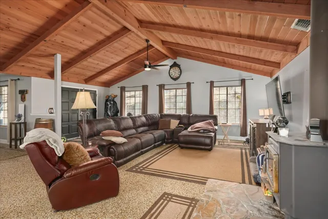 a living room with furniture a large window