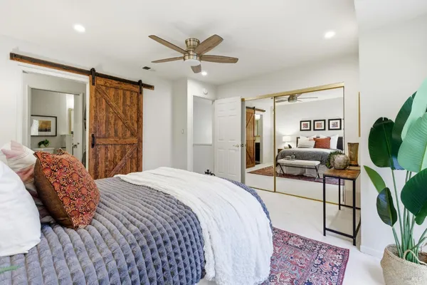 a bedroom with a bed and a chandelier