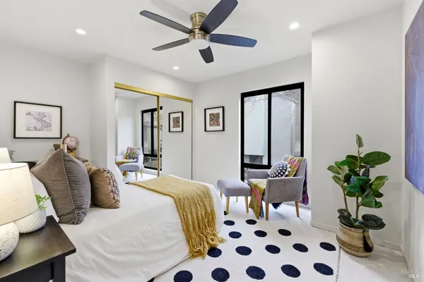 a bedroom with a bed and a potted plant