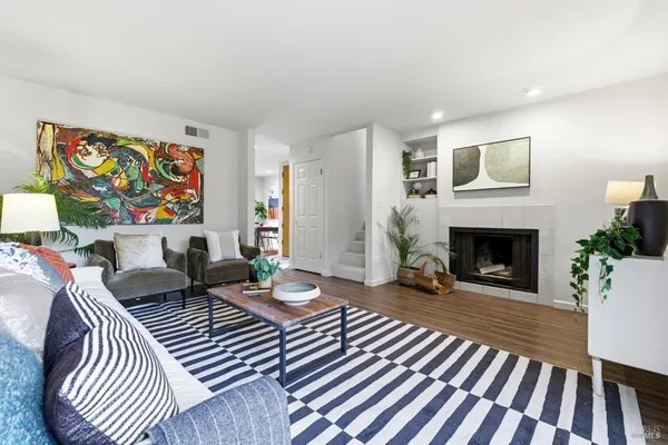 a living room with furniture and a fireplace