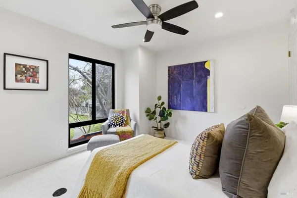 a bed room with a bed and a large window