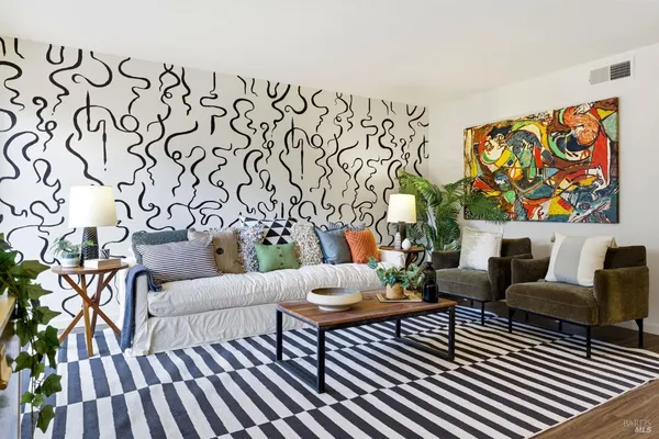 a living room with furniture and wooden floor