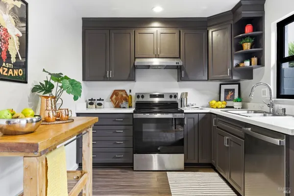 a kitchen with a sink stove and cabinets
