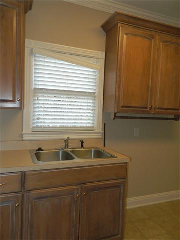 3207 Pugh Road Hermitage, TN 37076 - Photo 12 of 20 Utility Room: 9 x 12—Large utility room offering tile flooring wall cabinets, base cabinet with utility sink and full walk-in shower. Located on the main level.