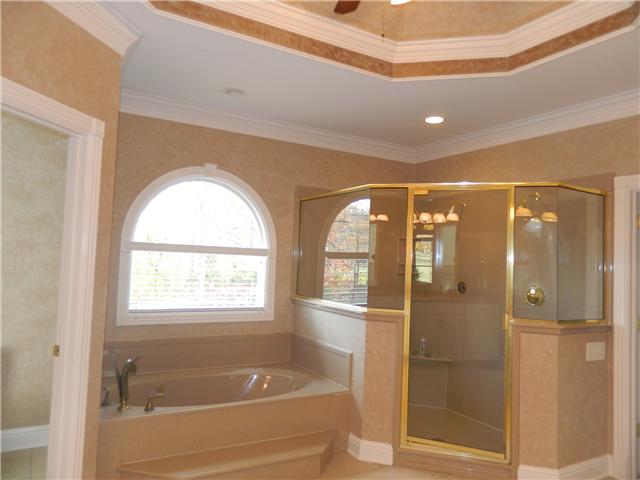 3207 Pugh Road Hermitage, TN 37076 - Photo 14 of 20 Spacious bath with His & Her vanities, dressing area with knee space, vaulted treyed ceiling with trim, tile flooring, oversized separate tiled shower with corner seat, whirlpool tub with fixed palladium window above, private water closet and linen