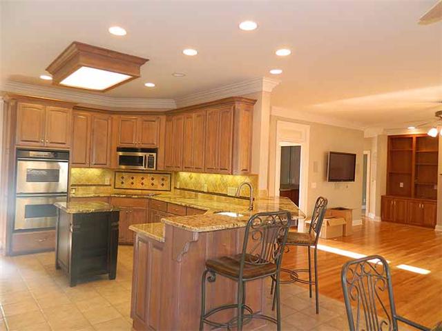 3207 Pugh Road Hermitage, TN 37076 - Photo 7 of 20 Kitchen 15x12 100% renovated and offers stainless appliances with built in double ovens, cooktop with over the range microwave, refrigerator with matching wood panels, glass front cabinets, solid exotic granite countertops, tiled backsplash