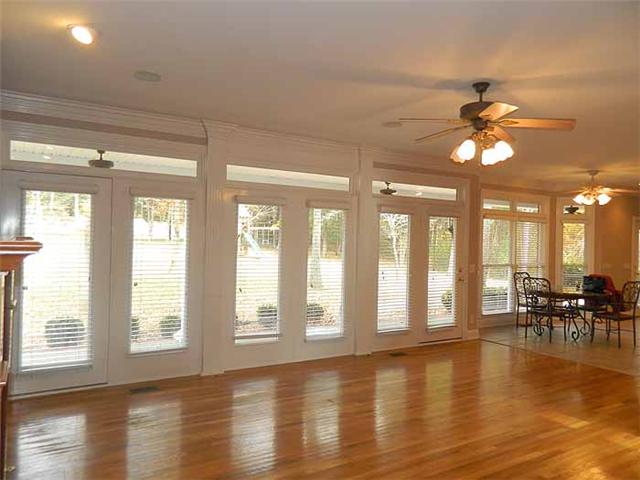 3207 Pugh Road Hermitage, TN 37076 - Photo 9 of 20 Den: 21 x 17 custom built-in bookcases, gas fireplace, wet bar, hardwood flooring, crown molding, recessed lighting, two sets of French doors, transom windows with wood blinds