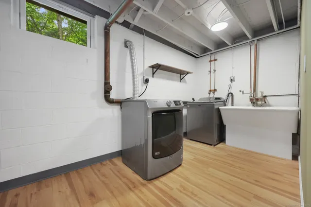 a kitchen with stainless steel appliances granite countertop a sink counter space and wooden floor