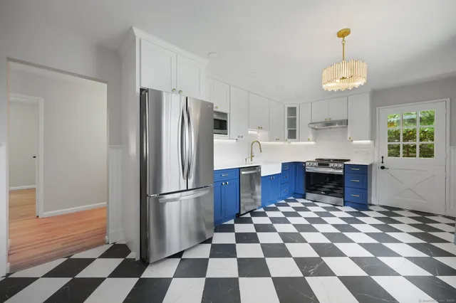 a kitchen with a checkered floor and a refrigerator