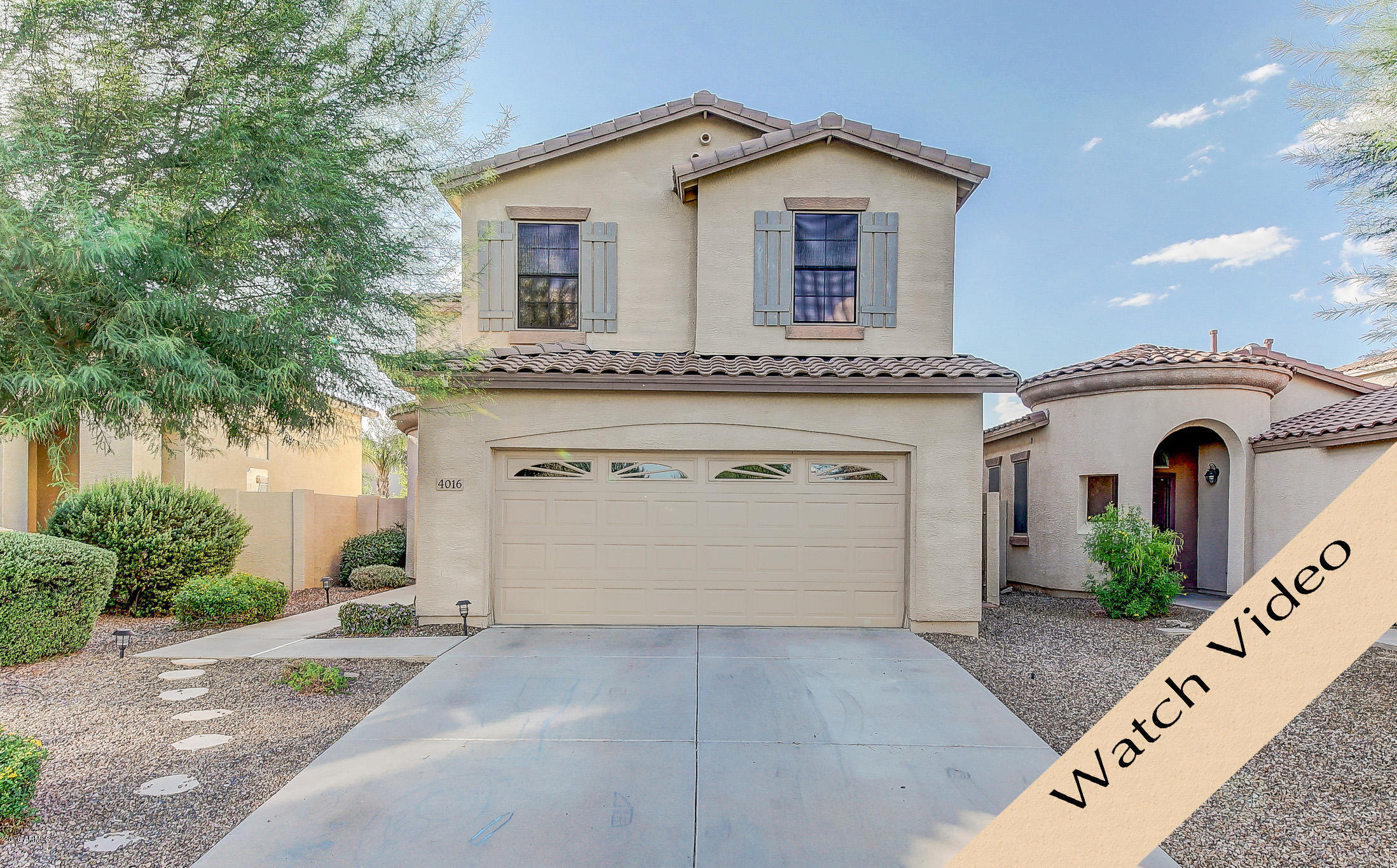 4016 East Ironhorse Road Gilbert, AZ 85297 - Photo 1 of 48 a front view of a house with a yard and garage