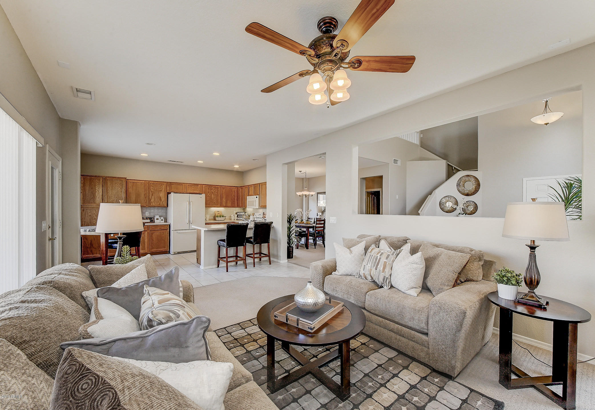 4016 East Ironhorse Road Gilbert, AZ 85297 - Photo 11 of 48 a living room with furniture kitchen view and a chandelier