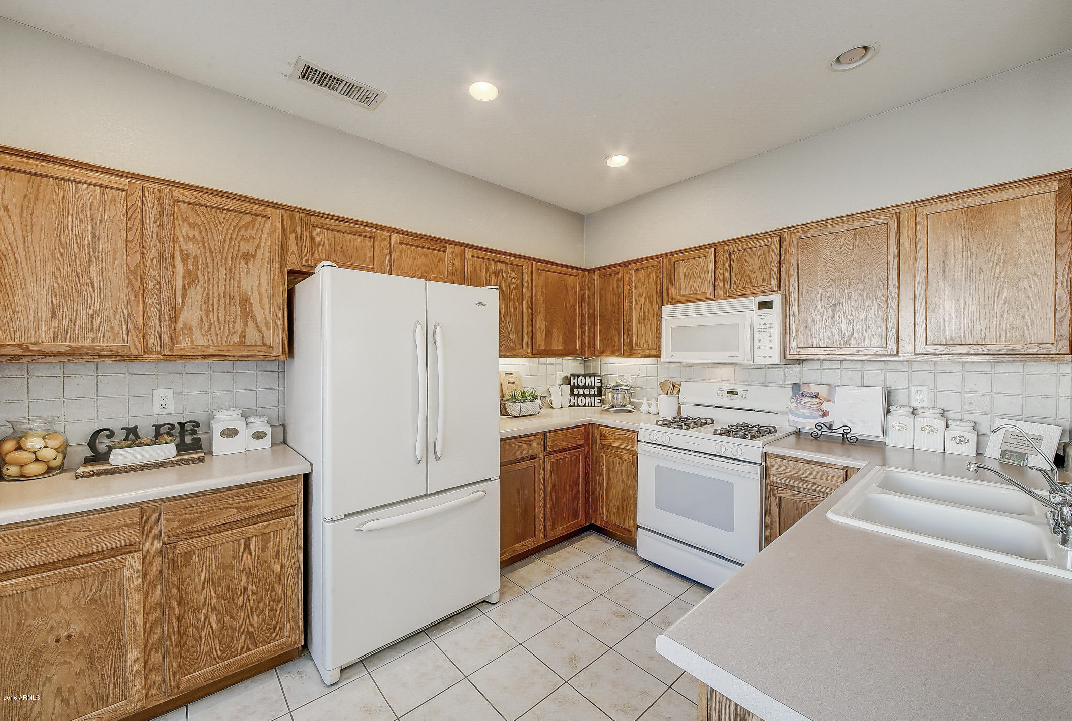 4016 East Ironhorse Road Gilbert, AZ 85297 - Photo 15 of 48 a kitchen with appliances cabinets and a sink