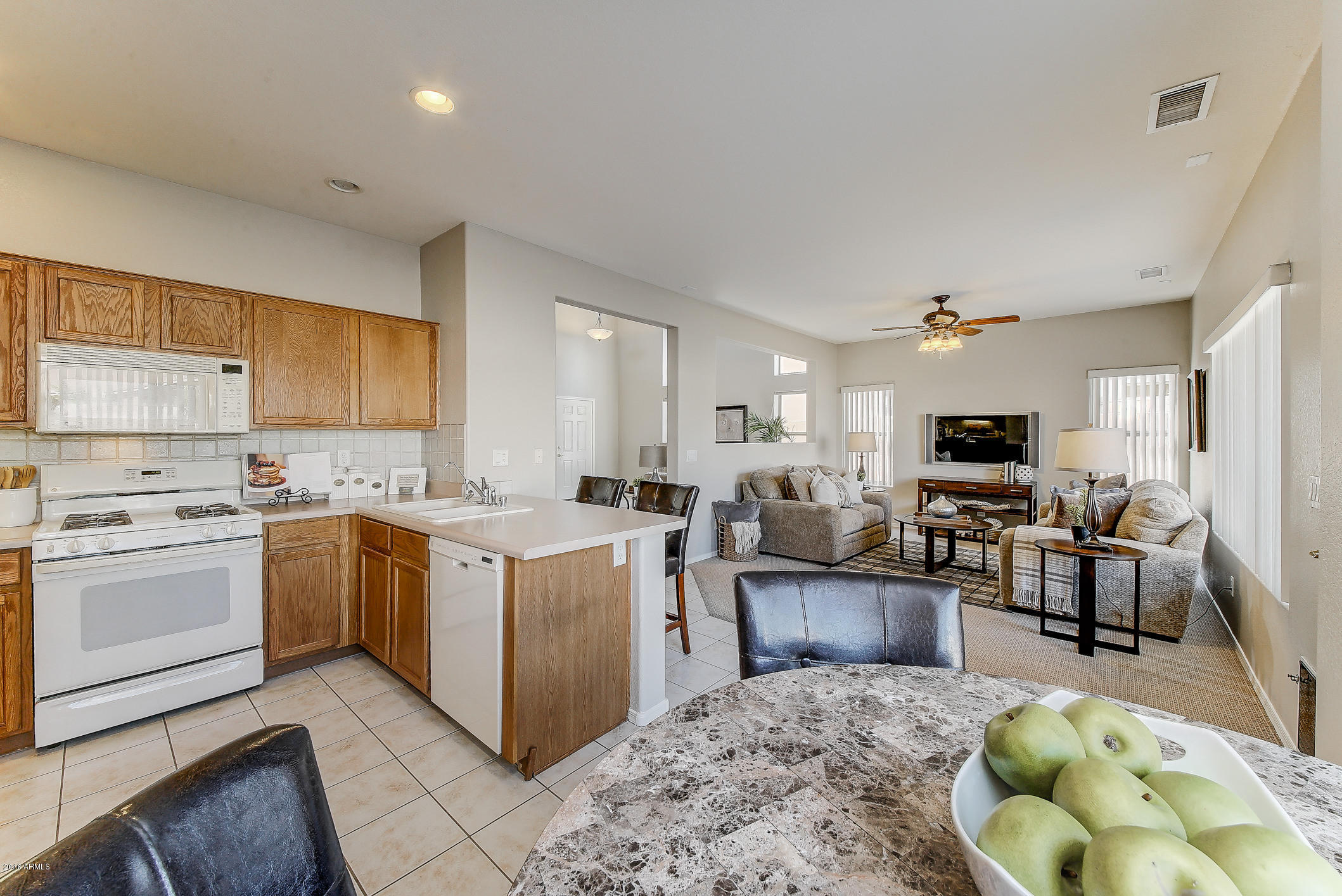 4016 East Ironhorse Road Gilbert, AZ 85297 - Photo 17 of 48 a kitchen with a stove top oven and cabinets