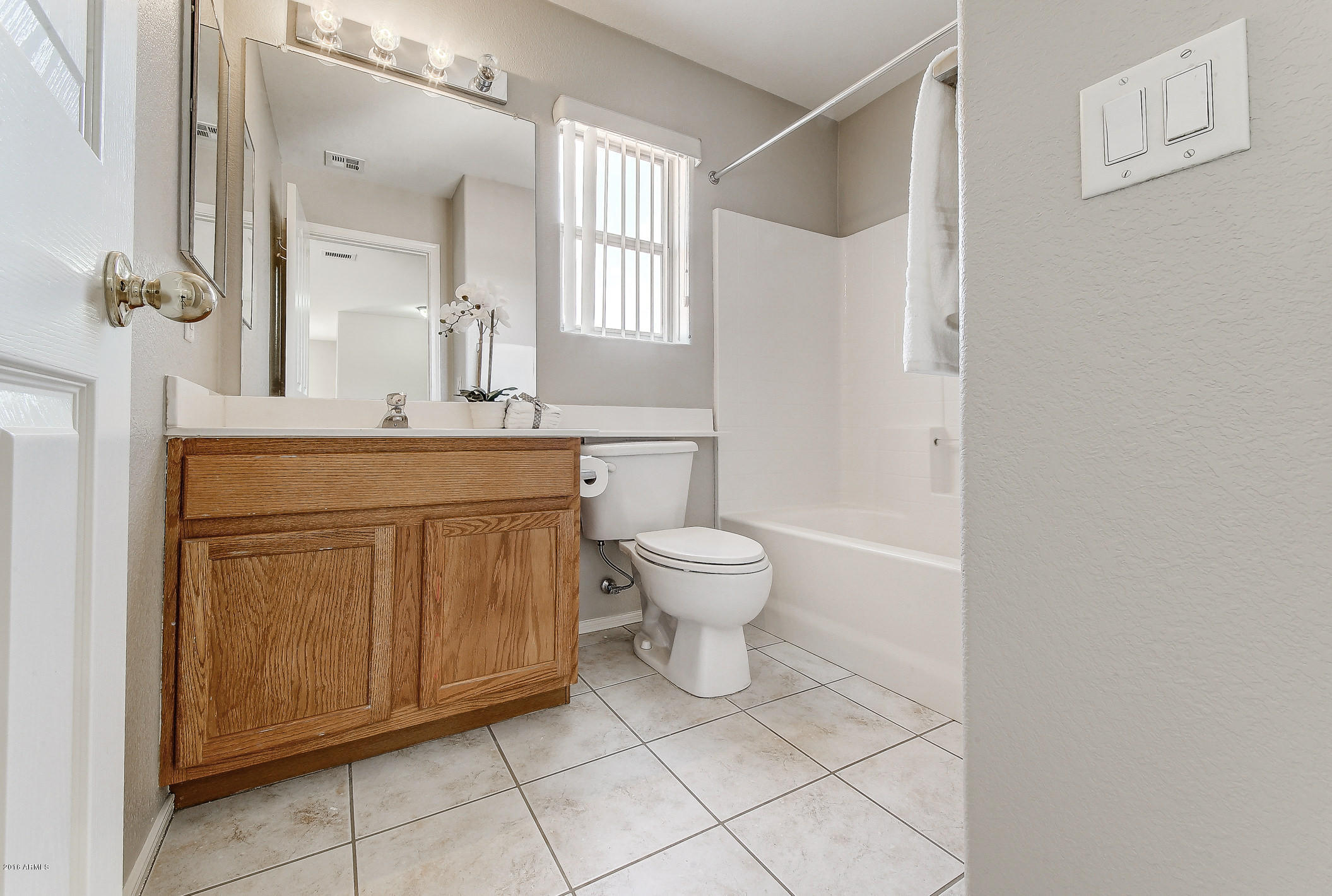 4016 East Ironhorse Road Gilbert, AZ 85297 - Photo 23 of 48 a spacious bathroom with a granite countertop sink a toilet and a mirror