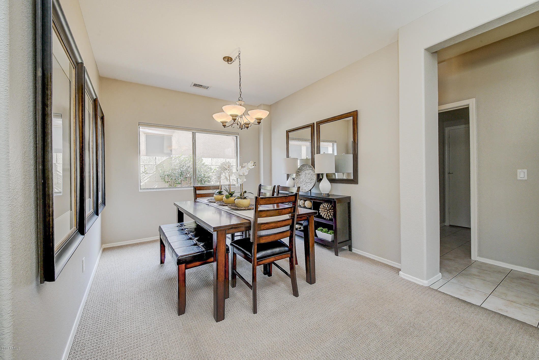 4016 East Ironhorse Road Gilbert, AZ 85297 - Photo 8 of 48 a view of a dining room with furniture and a chandelier