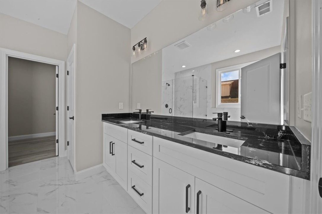 105 Bree Drive Anderson, SC 29621 - Photo 21 of 48 Dual vanities with stone counters and a spacious mirror create an inviting primary bathroom retreat.