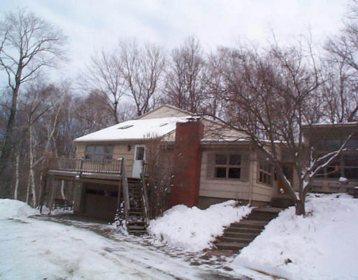 a view of a house with snow on the tree