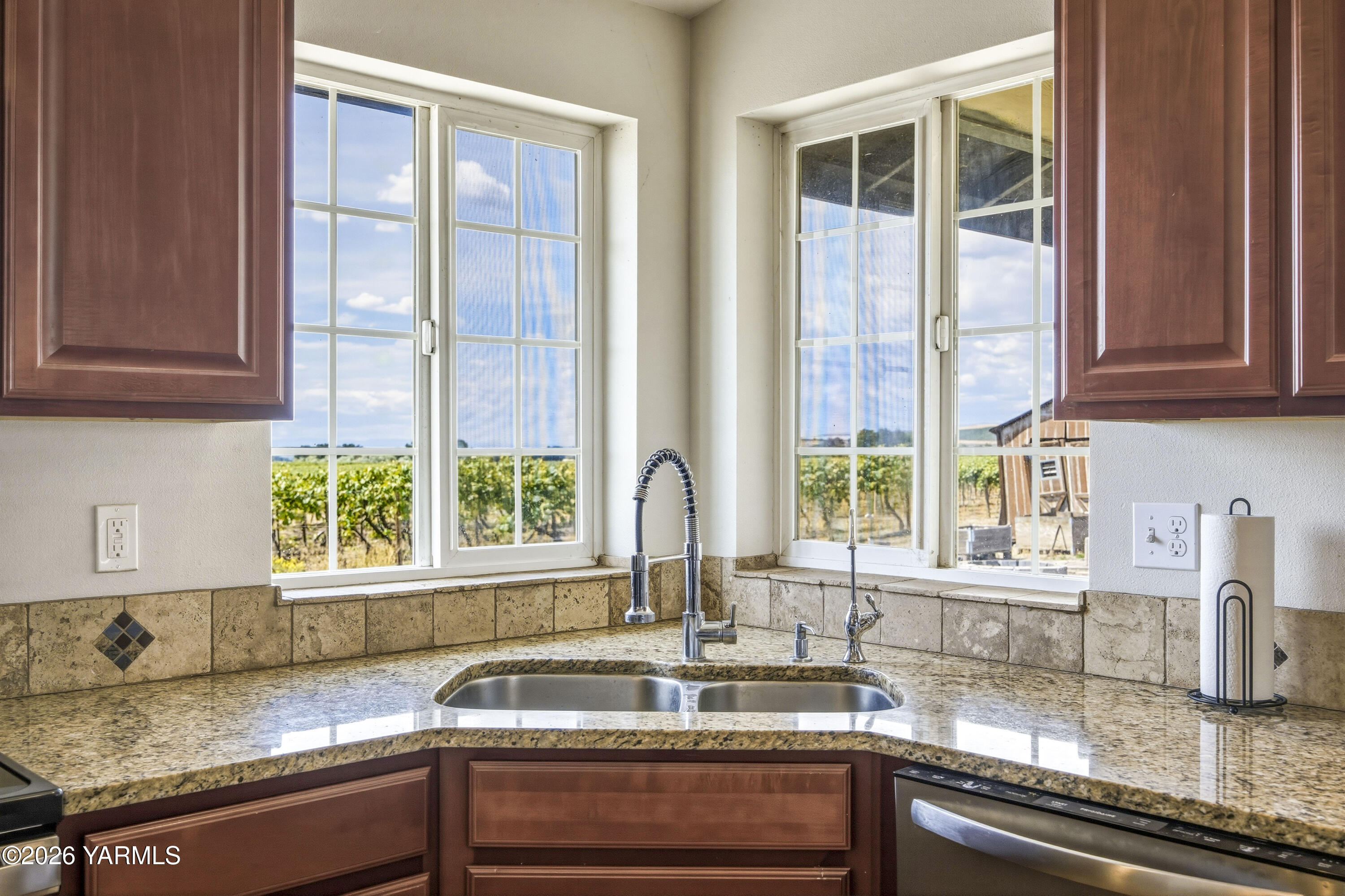 2050 Olmstead Road Grandview, WA 98930 - Photo 32 of 60 a kitchen with granite countertop a sink and a window