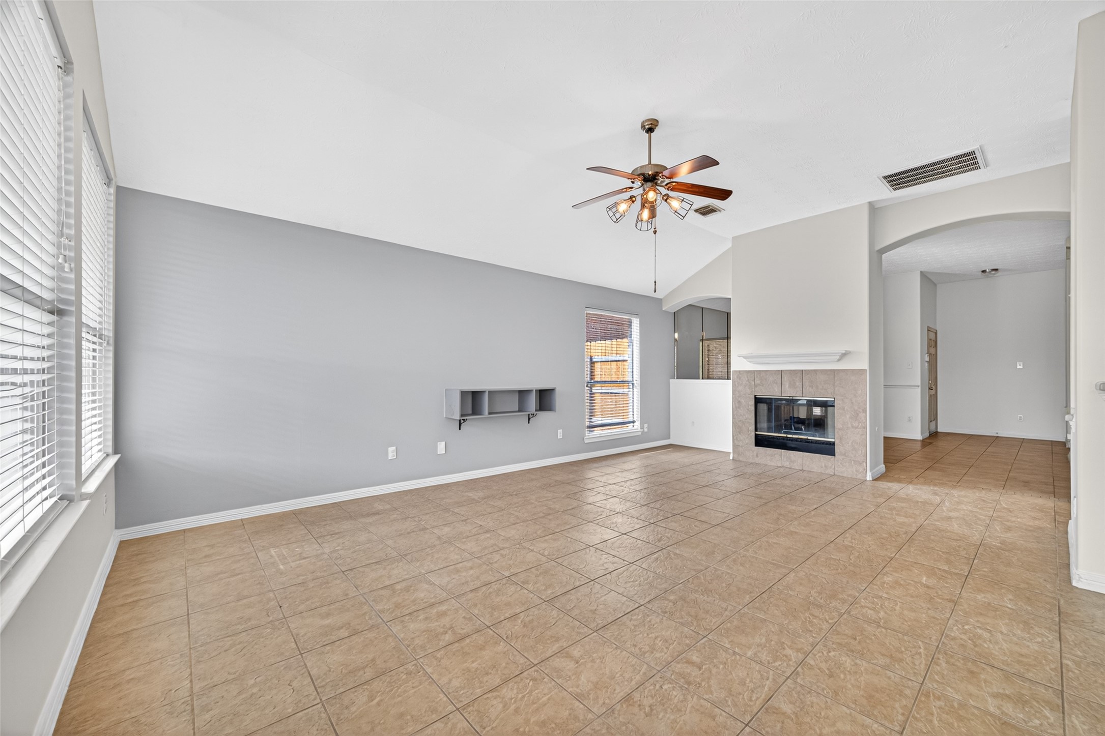 23914 Glengate Drive Spring, TX 77373 - Photo 13 of 49 a view of an empty room with a fireplace and a window