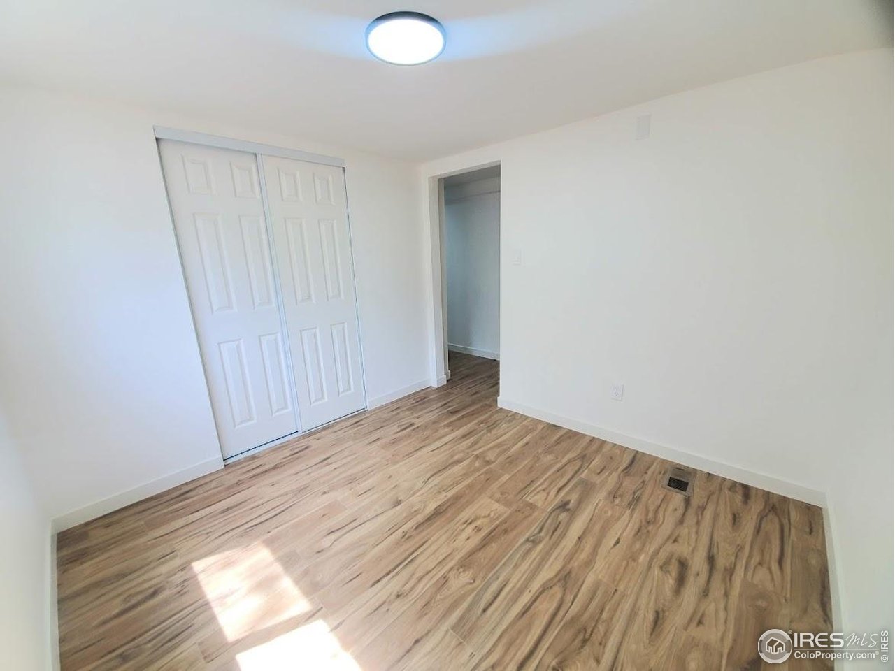1212 Butte Road, Unit 7 Loveland, CO 80537 - Photo 12 of 21 a view of empty room with wooden floor