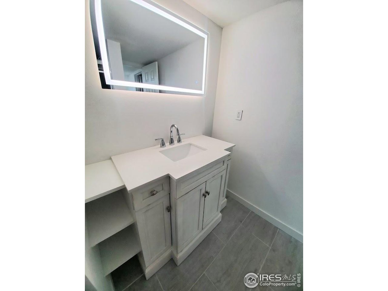 1212 Butte Road, Unit 7 Loveland, CO 80537 - Photo 14 of 21 a bathroom with a sink and a mirror