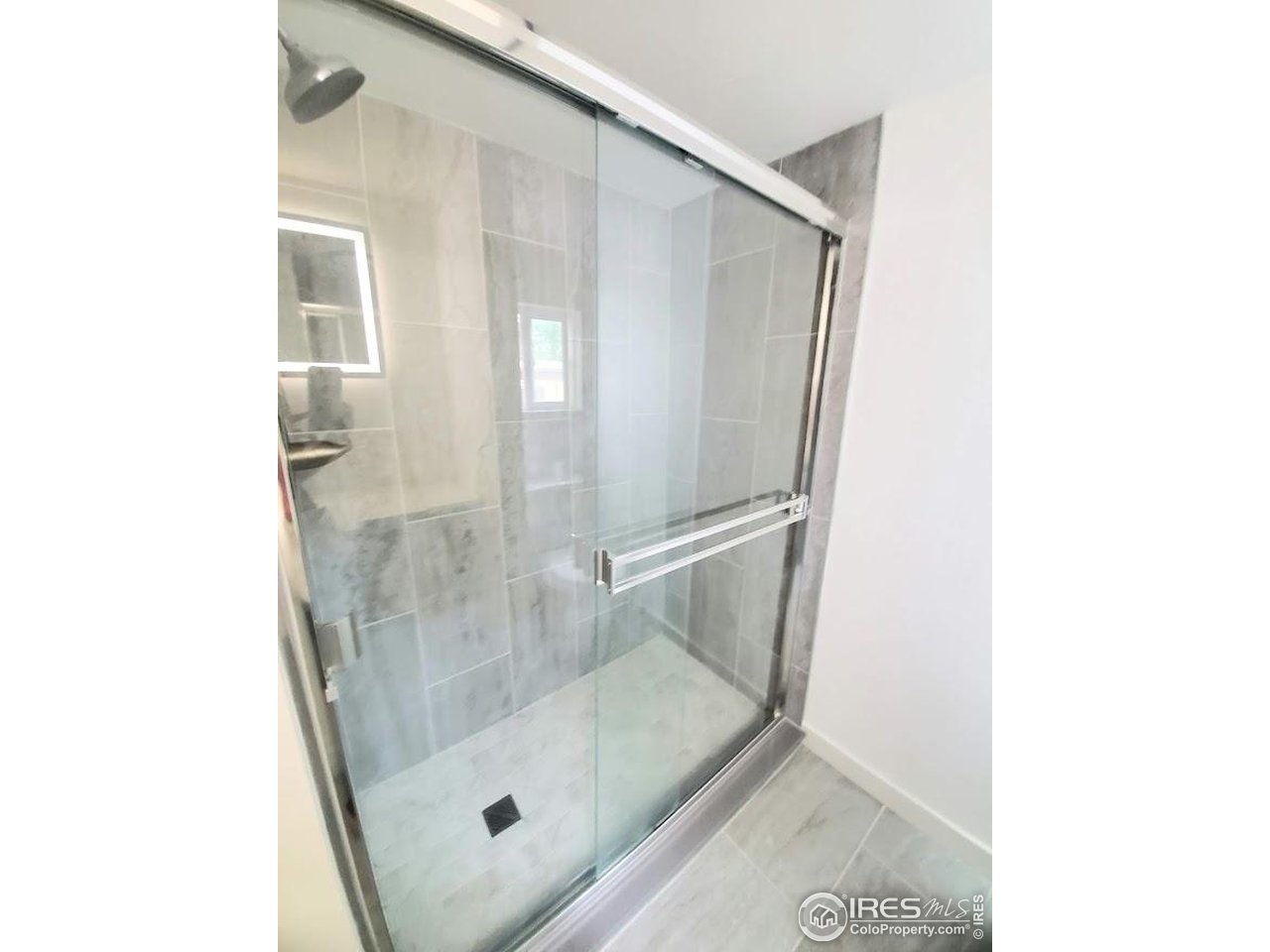 1212 Butte Road, Unit 7 Loveland, CO 80537 - Photo 15 of 21 a bathroom with a glass shower door