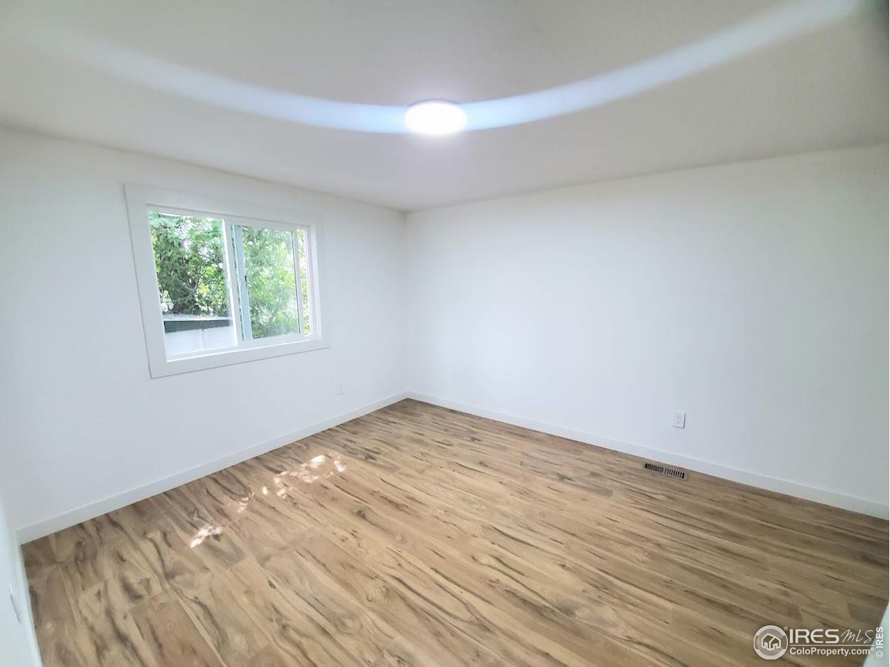 1212 Butte Road, Unit 7 Loveland, CO 80537 - Photo 16 of 21 a view of empty room with wooden floor