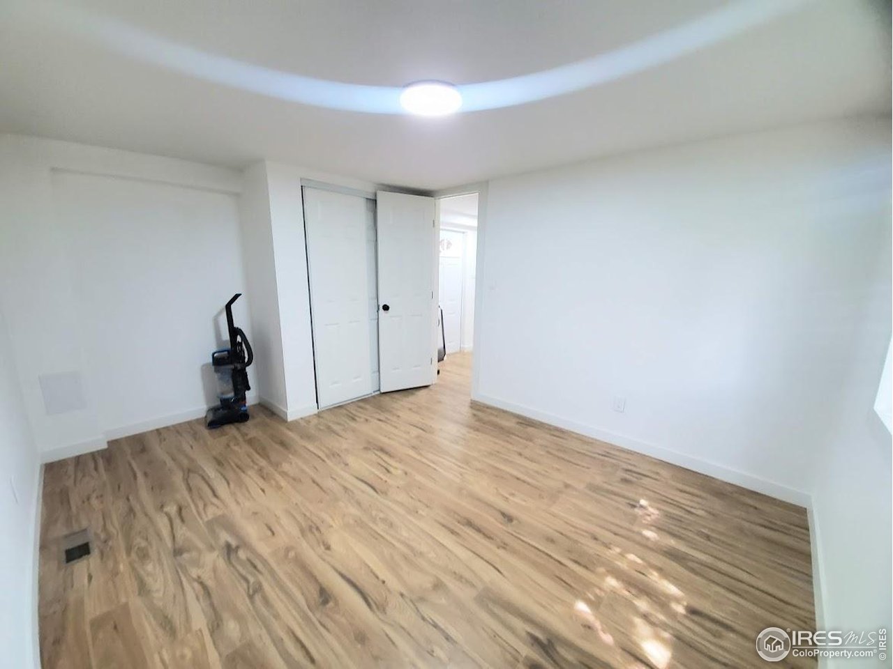 1212 Butte Road, Unit 7 Loveland, CO 80537 - Photo 17 of 21 a view of empty room with wooden floor and window