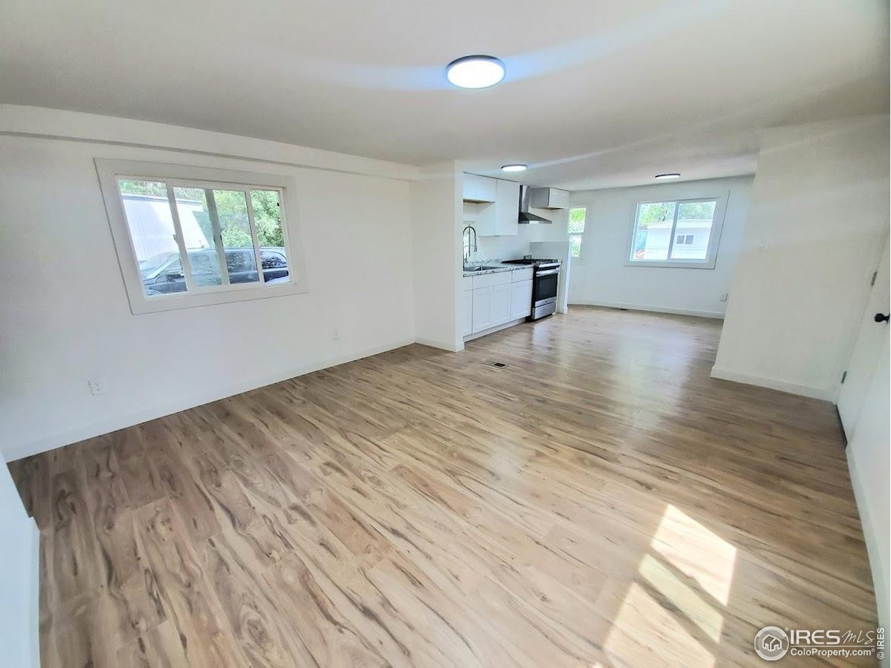 1212 Butte Road, Unit 7 Loveland, CO 80537 - Photo 5 of 21 a view of empty room with wooden floor and fan