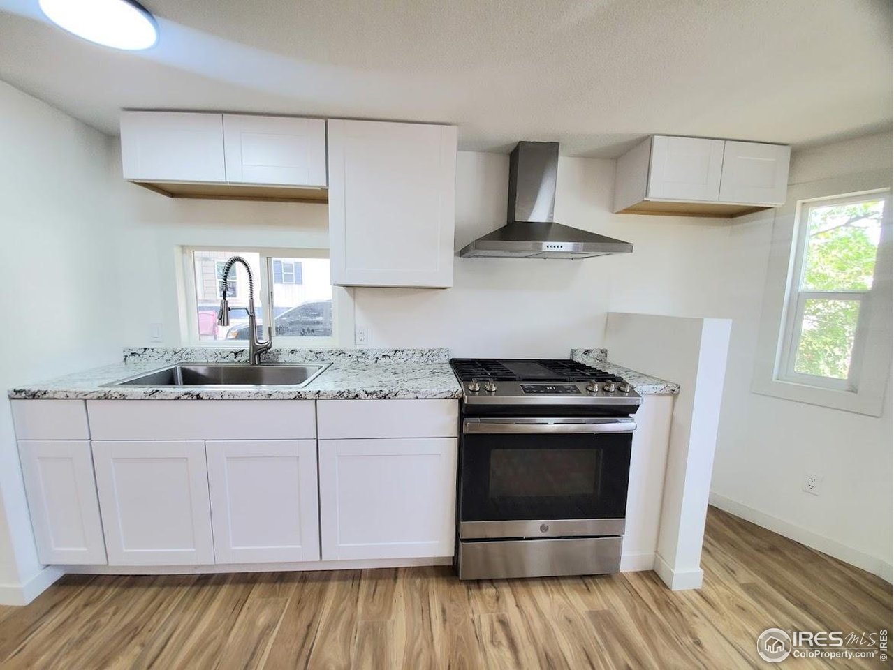 1212 Butte Road, Unit 7 Loveland, CO 80537 - Photo 8 of 21 a kitchen with granite countertop a stove and a sink