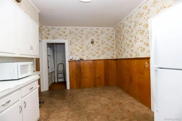 a view of hallway with bathroom and mirror