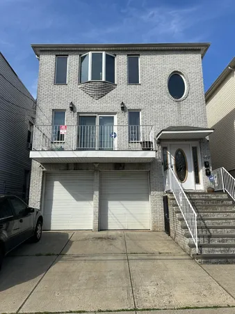 a view of front door of house with car parked