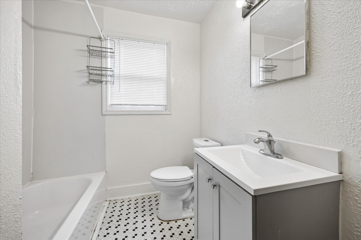 2308 McClendon Street, Unit 1 Houston, TX 77030 - Photo 9 of 15 Closer view of the combo tub/shower and updated sink. Efficiency toilet.