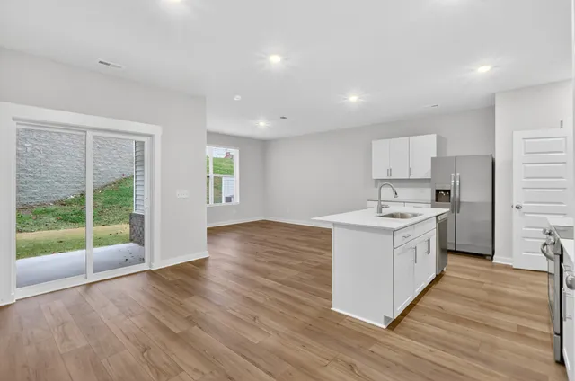 a kitchen with wooden floors and a sink