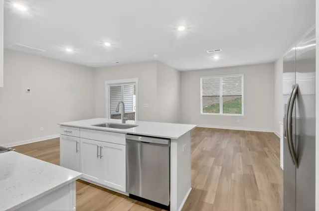 a view of a kitchen with a sink cabinets and wooden floor