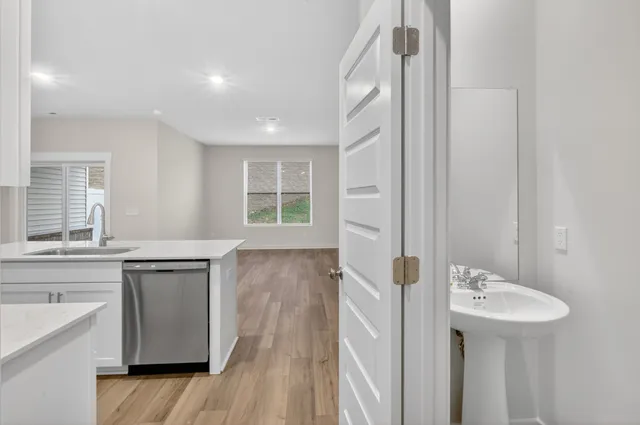 a spacious bathroom with a sink a mirror and a bathtub