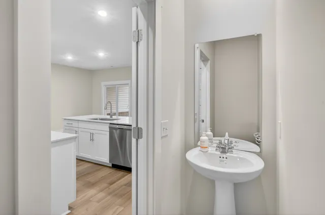 a bathroom with a sink a mirror and a toilet